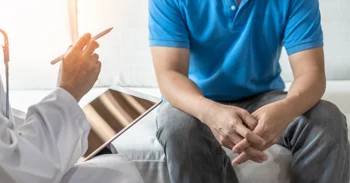Healthcare professional consulting a patient about hyperbaric oxygen therapy for men's health and recovery.