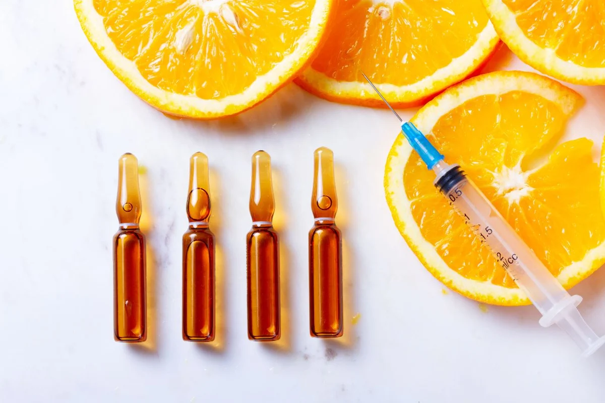 IV nutrient therapy ampoules with fresh oranges supporting cognitive function, mental clarity, and overall wellness.