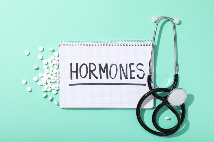 Notebook labeled hormones with a stethoscope representing hormone health evaluation and hormonal imbalance symptoms.