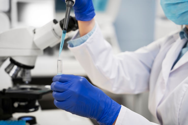 Laboratory professional handling medical testing equipment during advanced functional medicine diagnostics.
