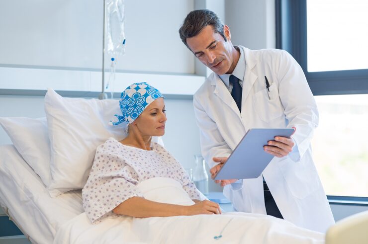 Healthcare provider reviewing a personalized cancer wellness plan with a patient during a follow-up consultation.