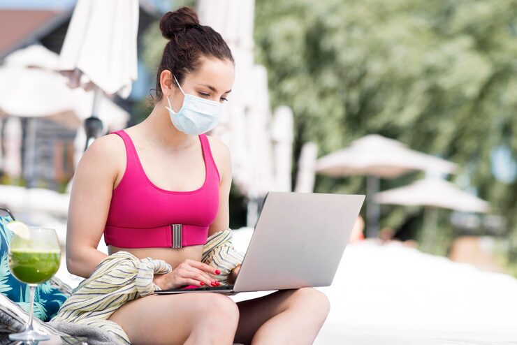 Woman attending a virtual functional medicine consultation on a laptop while outdoors