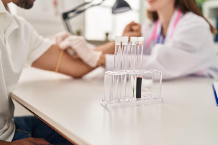 Healthcare professional collecting a blood sample for comprehensive genetic health testing.