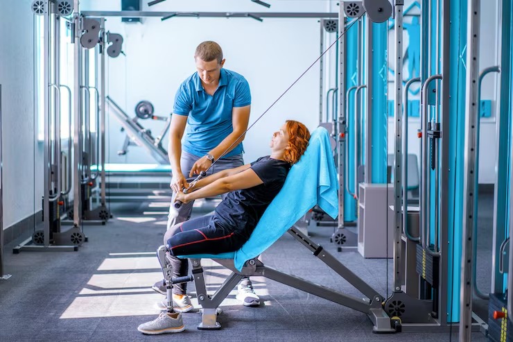 Patient performing rehabilitation exercises with a physical therapist for injury recovery and improved mobility.