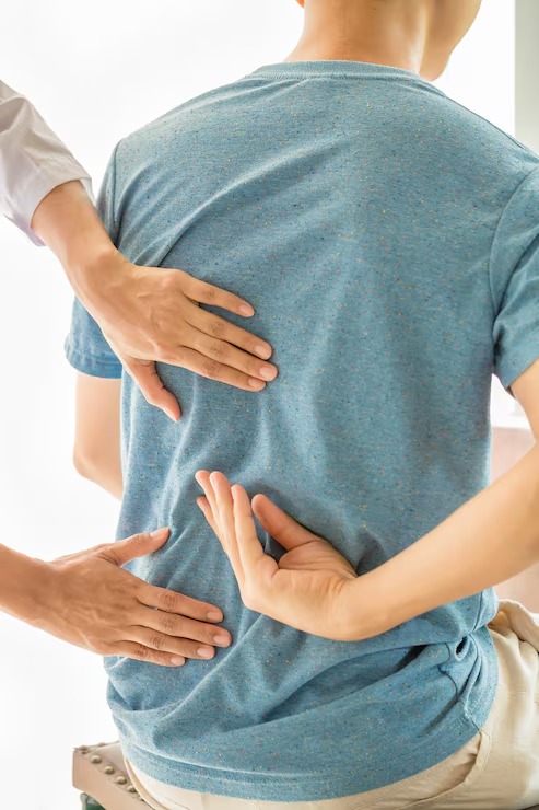 Chiropractor performing a spinal assessment during a personalized chiropractic consultation.