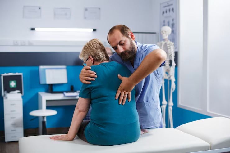 Chiropractor assisting a patient during a chiropractic treatment session in a modern clinic.