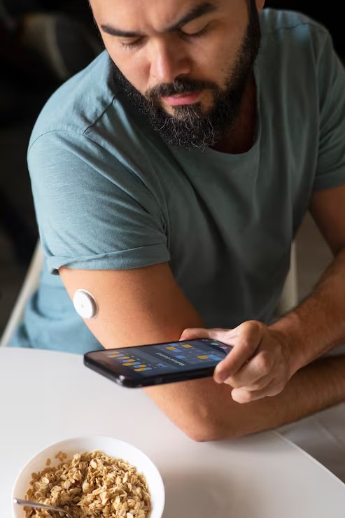 Person using a smartphone to review continuous glucose monitoring (CGM) data during a personalized health assessment.