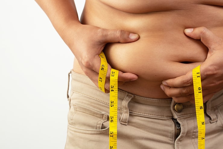 Measuring tape around the waist representing healthy weight management and metabolic wellness.