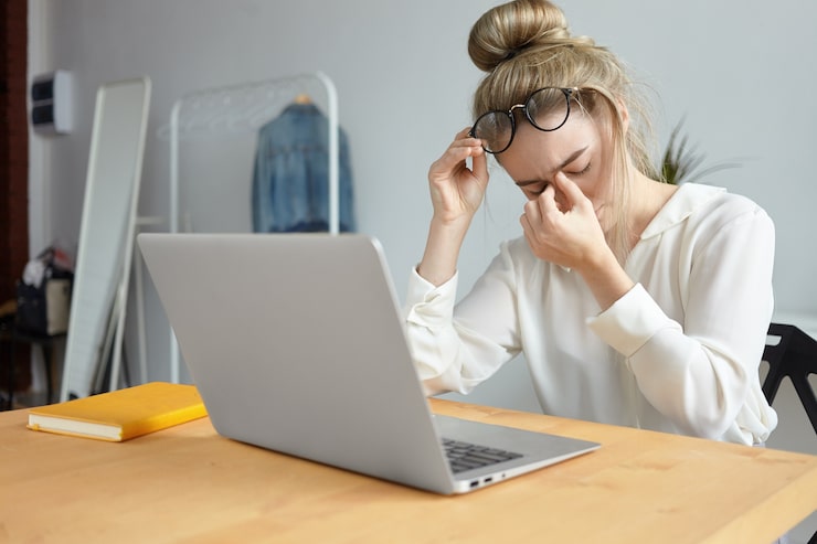 Person experiencing fatigue while working, representing chronic fatigue support through functional medicine.