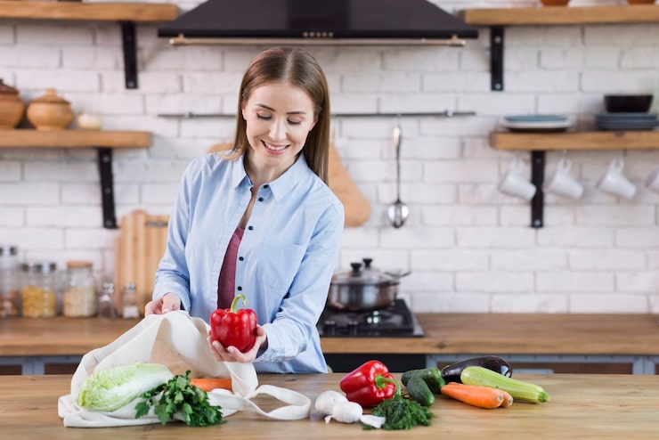 Woman preparing fresh vegetables to support a healthy lifestyle and reduce environmental toxin exposure.
