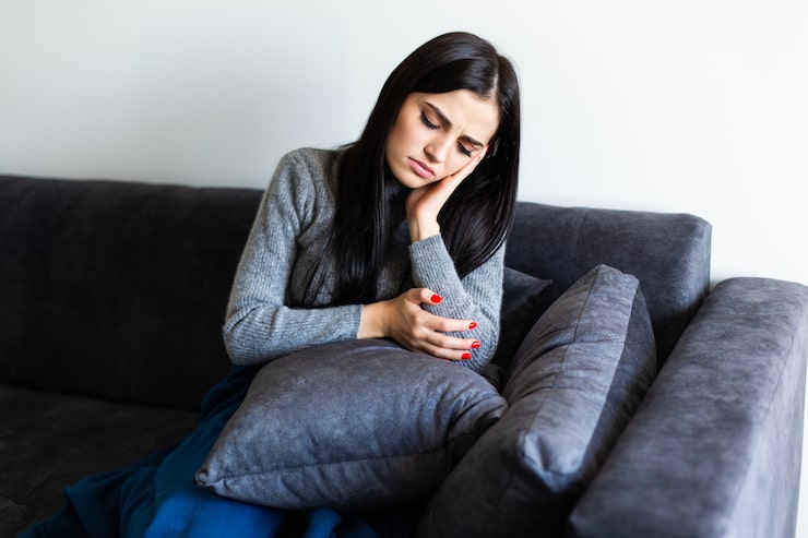 Woman experiencing hormonal imbalance symptoms while receiving support through personalized functional medicine care.