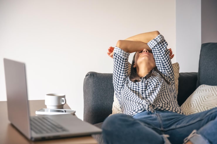 Person stretching while working from home, representing improved energy and daily wellness.